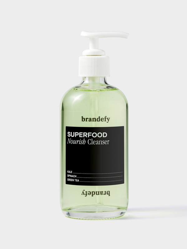 Superfood Nourish Cleanser in a clear pump bottle with green liquid.