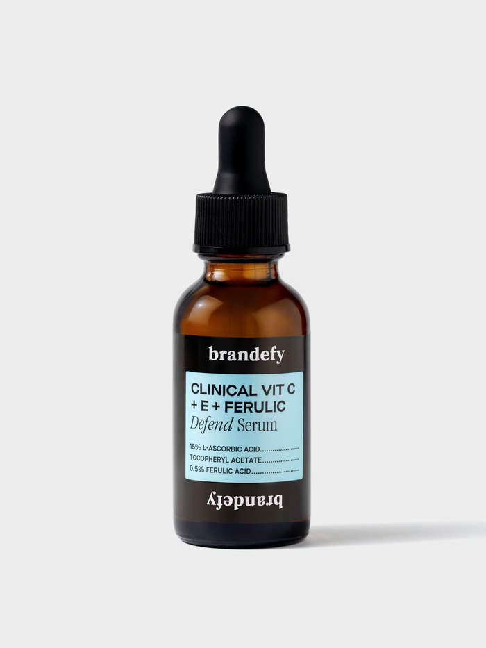 Amber glass dropper bottle of Brandefy Clinical Vit C + E + Ferulic Defend Serum with a light blue label.