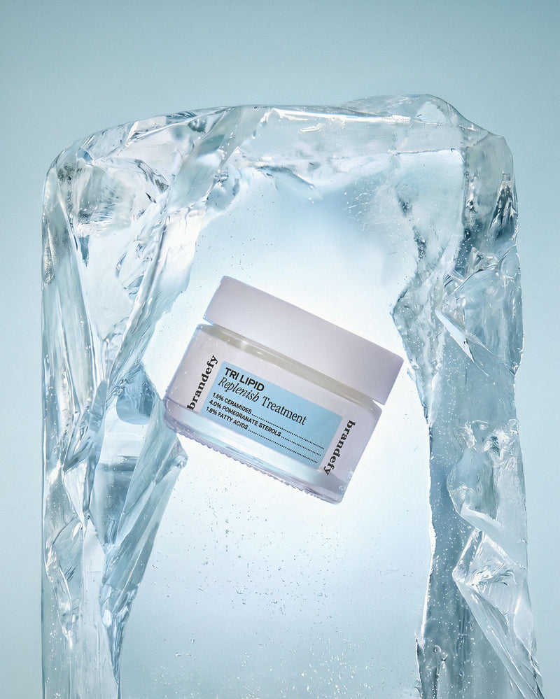 The Tri Lipid Replenish Treatment jar set against a clear block of ice.