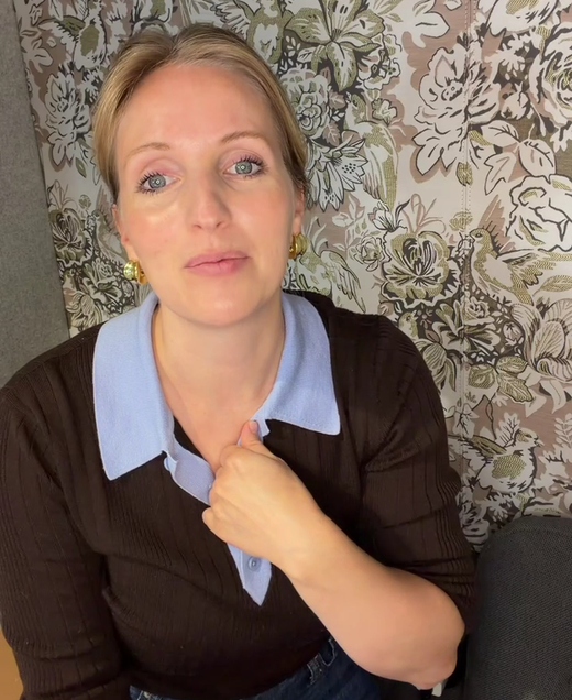 Meg Pryde, Brandefy's founder, speaking to camera in a home office with a floral upholstered panel behind her.